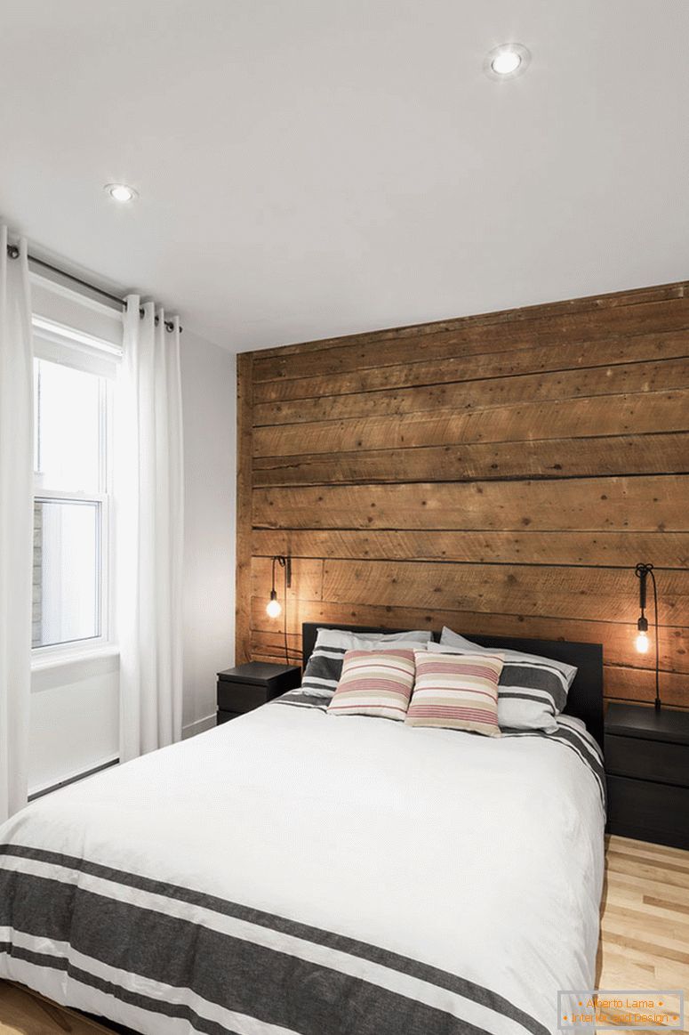 Drewniana ściana akcentująca we wnętrzu małej sypialni