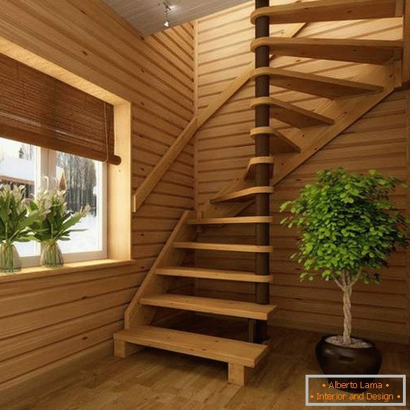 Nowoczesne schody spiralne w prywatnym domu z drewna