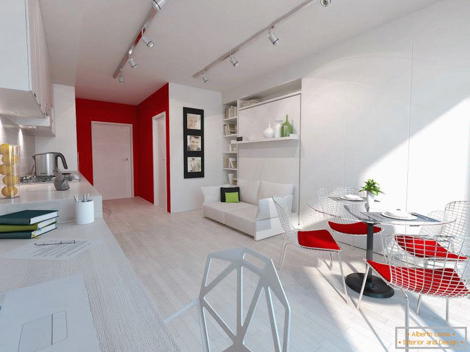 Białe wnętrze małego apartamentu z czerwonymi akcentami