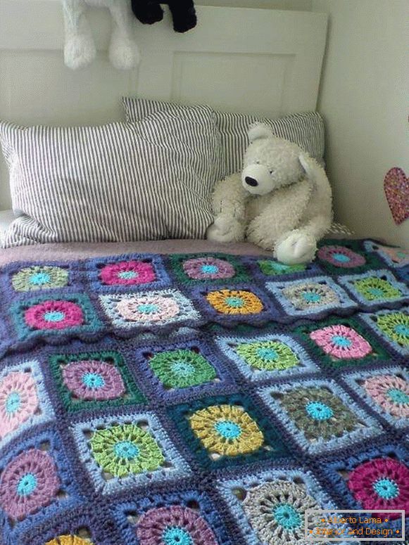 Dzianinowa narzuta na łóżko w pokoju dziecinnym w stylu patchworku