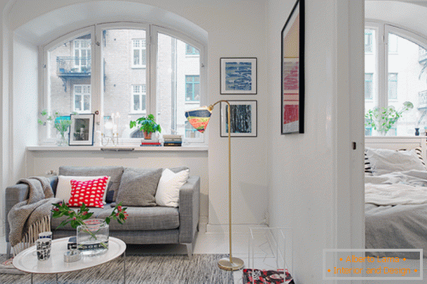 Salon i sypialnia małego mieszkania w skandynawskim stylu