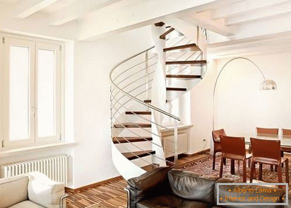 Spiralne schody w prywatnym domu z drewna i metalu