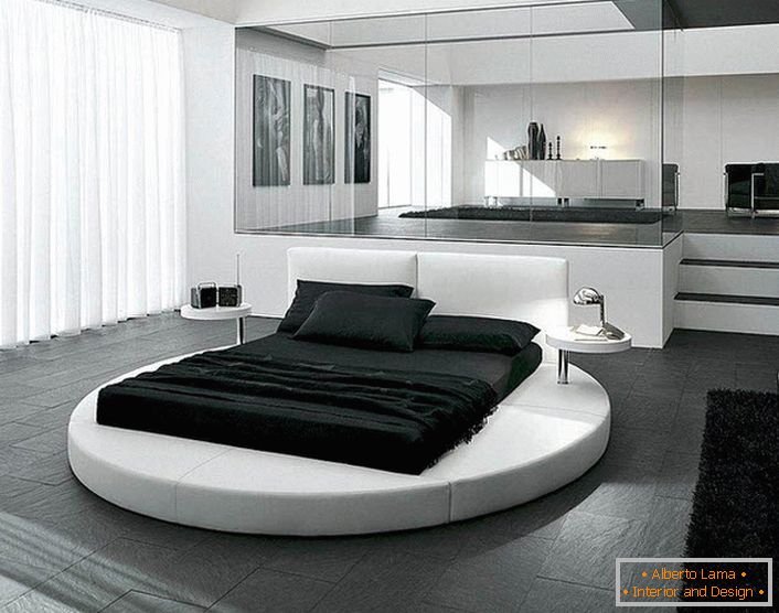 Projekt sypialni w stylu minimalizmu podkreślają odpowiednio dobrane meble. Ciekawym detalem wnętrza jest okrągłe łóżko.